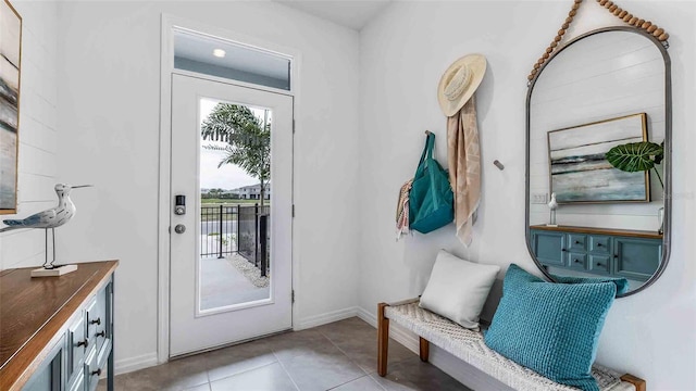 interior space featuring baseboards and light tile patterned flooring