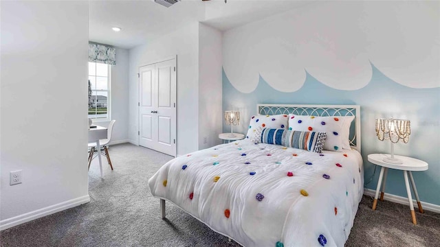 carpeted bedroom with visible vents, baseboards, and a closet