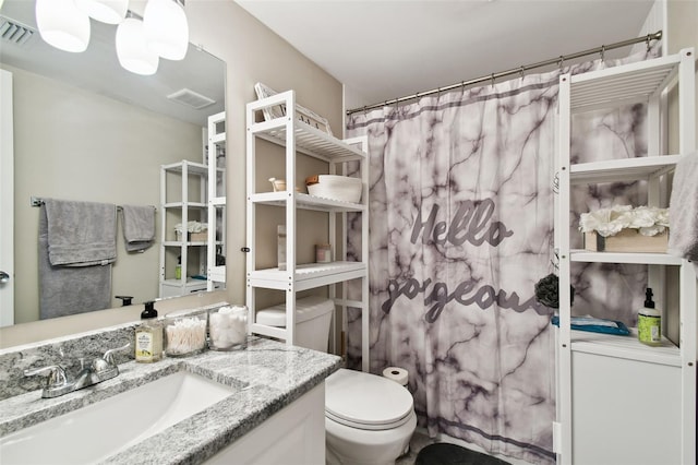 bathroom featuring vanity and toilet