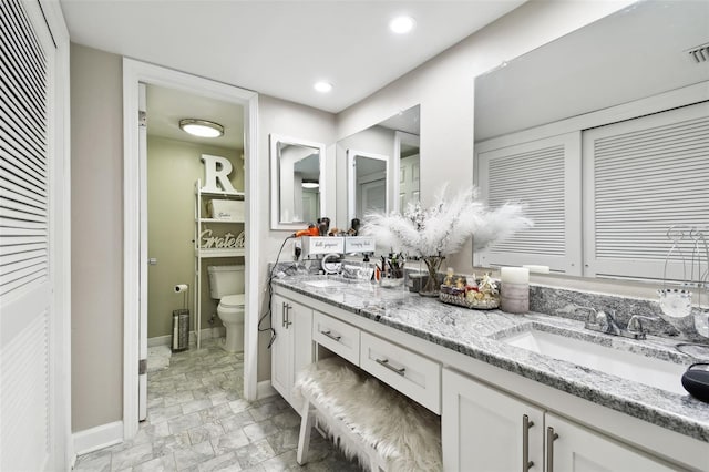 bathroom with vanity and toilet