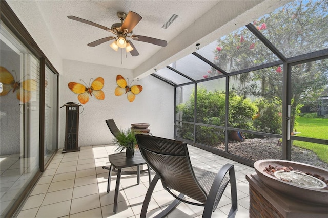 sunroom / solarium with beam ceiling and ceiling fan