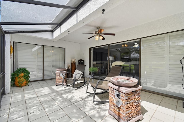 sunroom / solarium featuring ceiling fan