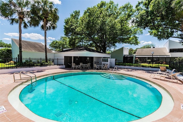 view of swimming pool with a patio