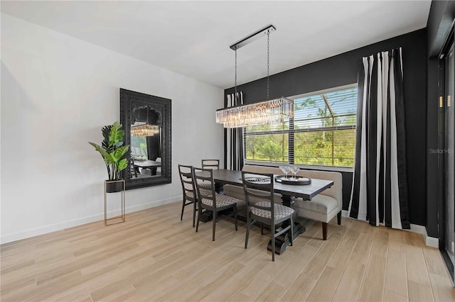 dining area with a chandelier and light hardwood / wood-style floors