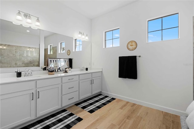 bathroom with a shower, vanity, and hardwood / wood-style flooring