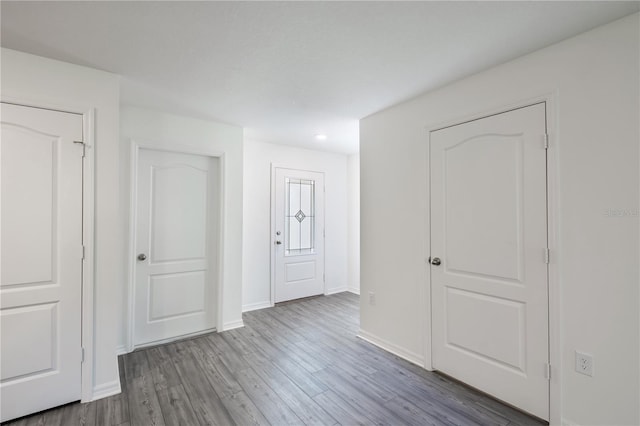 empty room with light hardwood / wood-style flooring