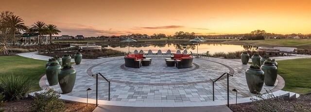 surrounding community featuring a patio and a water view