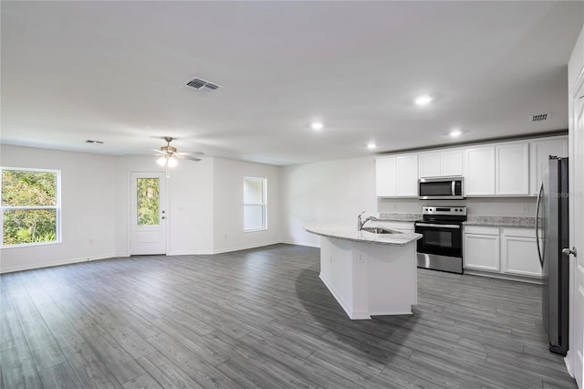 kitchen featuring white cabinets, sink, stainless steel appliances, and hardwood / wood-style floors