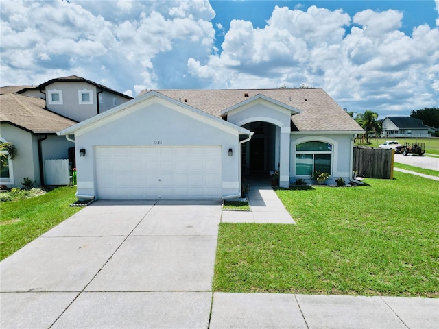 view of front of home with a front yard and a garage