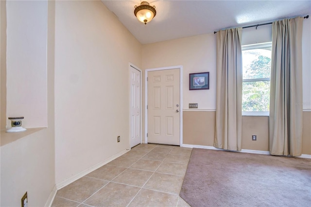 tiled foyer featuring plenty of natural light