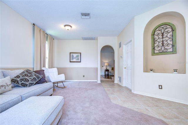 living room featuring light tile patterned floors and a textured ceiling