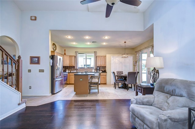 living room with ceiling fan, a healthy amount of sunlight, and light hardwood / wood-style floors