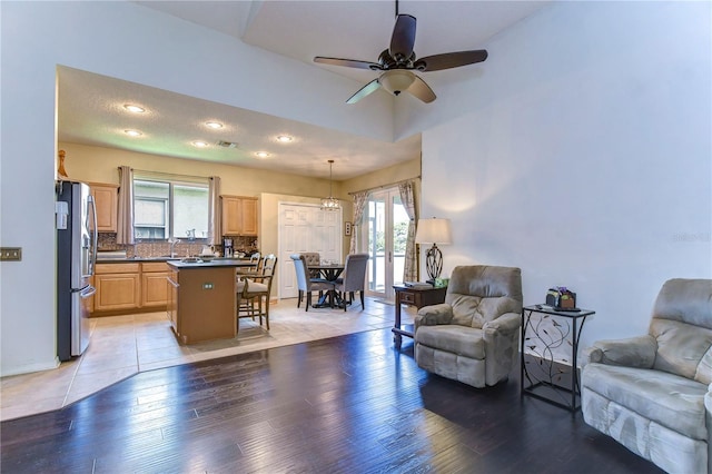 living room with light wood-type flooring and ceiling fan