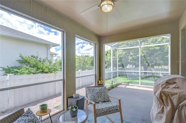 sunroom / solarium featuring ceiling fan