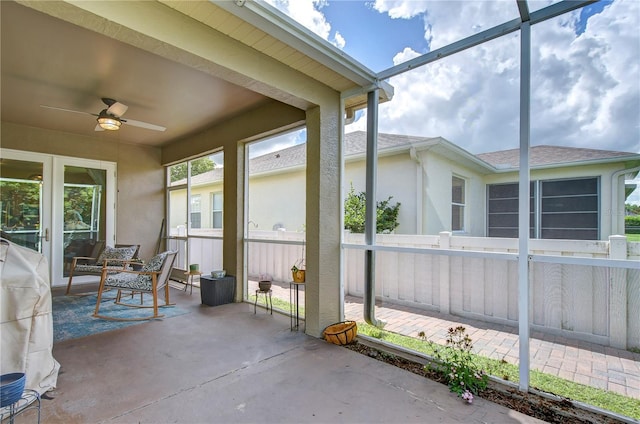 unfurnished sunroom with ceiling fan and a healthy amount of sunlight