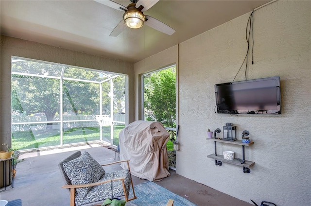 sunroom / solarium featuring ceiling fan