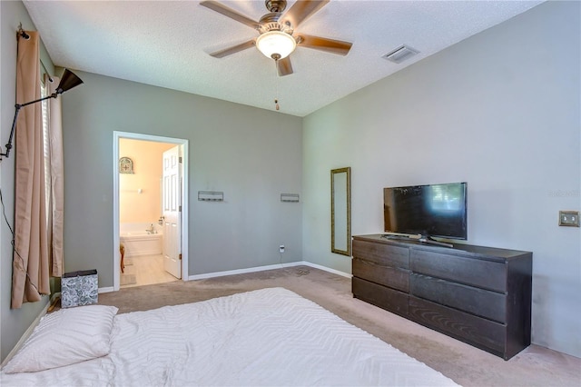 carpeted bedroom featuring a textured ceiling, ceiling fan, and connected bathroom