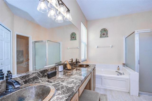 bathroom with vanity and independent shower and bath