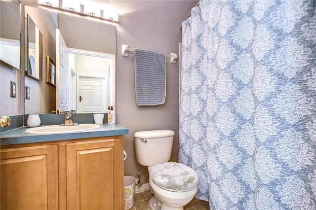 bathroom featuring toilet, vanity, tile patterned floors, and a shower with shower curtain