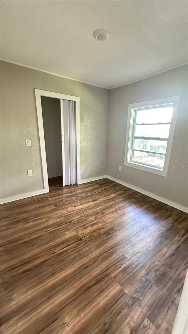 spare room with dark hardwood / wood-style floors