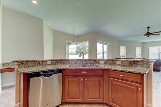 kitchen with light stone countertops, ceiling fan, sink, dishwasher, and hanging light fixtures