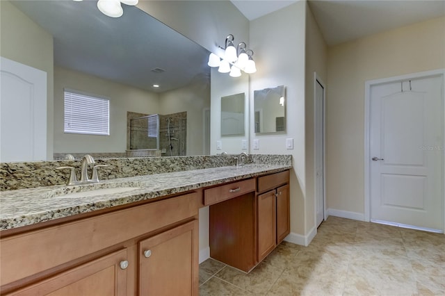 bathroom with tile patterned flooring, vanity, and walk in shower