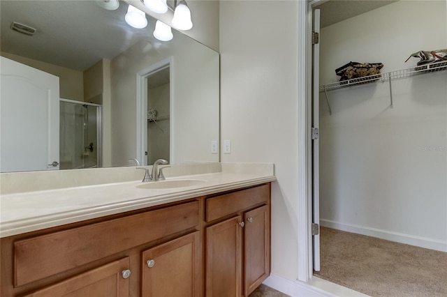 bathroom featuring vanity and an enclosed shower