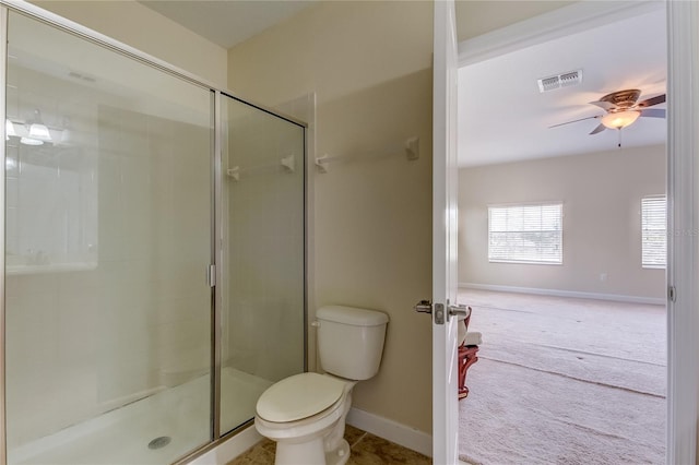 bathroom featuring toilet, ceiling fan, and an enclosed shower