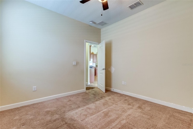 empty room with ceiling fan and light colored carpet