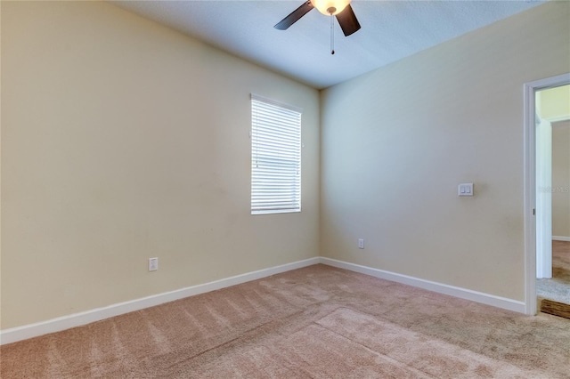 carpeted spare room with ceiling fan