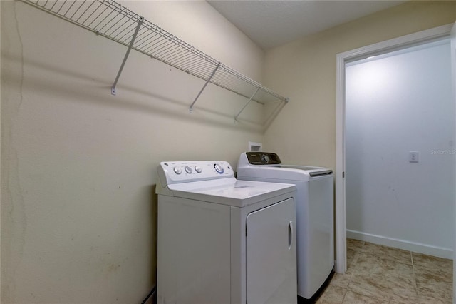 washroom with washing machine and clothes dryer