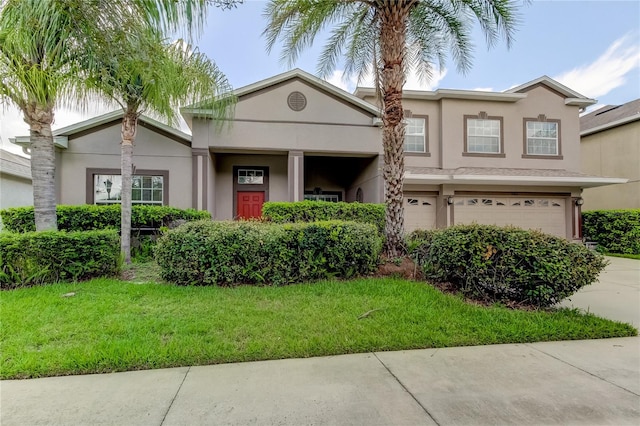 view of front of home featuring a front lawn and a garage