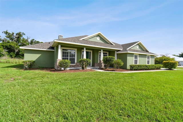 ranch-style home featuring a porch and a front lawn