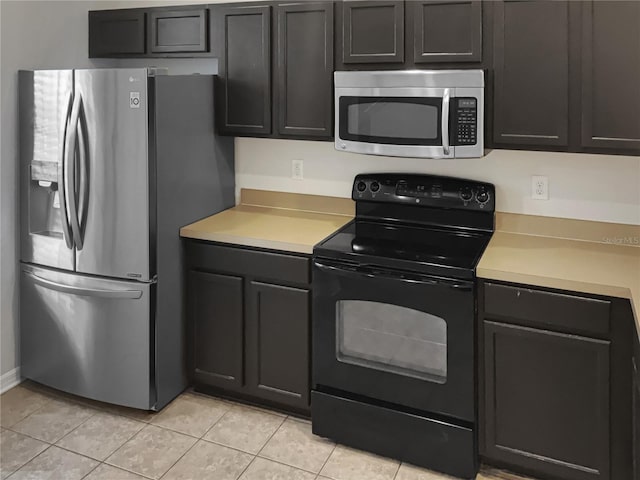 kitchen featuring light tile floors and stainless steel appliances