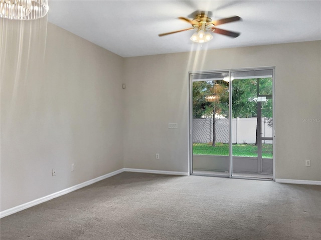 carpeted spare room with ceiling fan