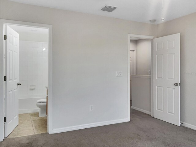 unfurnished bedroom with carpet and ensuite bath