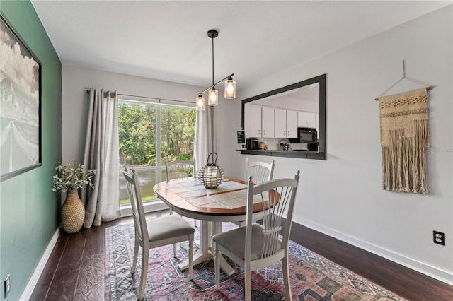 dining space with dark hardwood / wood-style floors