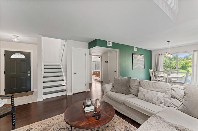 living room featuring hardwood / wood-style flooring and a chandelier