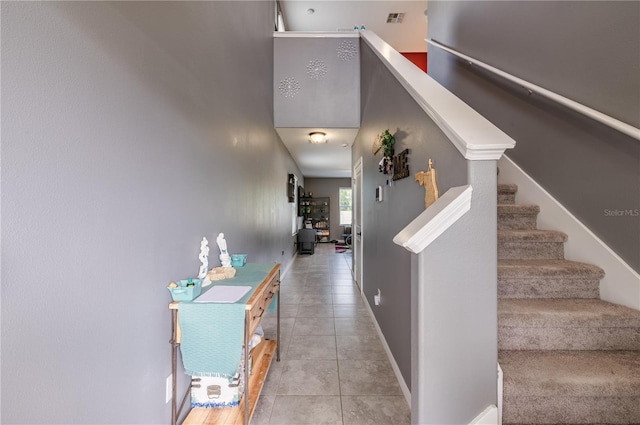 staircase featuring tile patterned floors