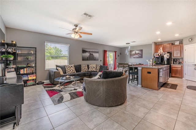 tiled living room with sink and ceiling fan