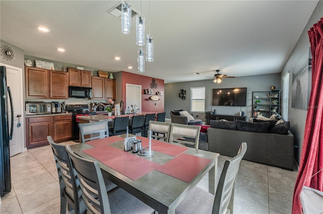 dining space with ceiling fan and light tile patterned floors