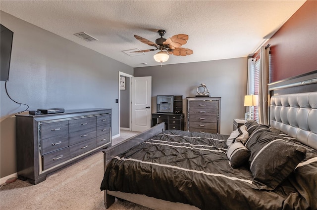 carpeted bedroom with a textured ceiling and ceiling fan