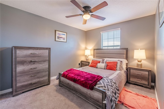 carpeted bedroom featuring a textured ceiling and ceiling fan