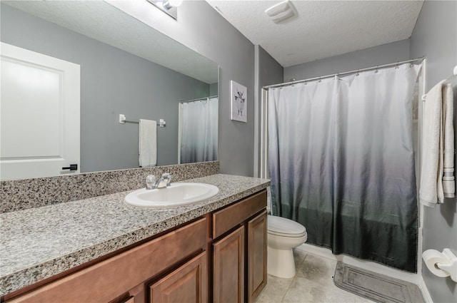 bathroom featuring vanity, toilet, and a textured ceiling