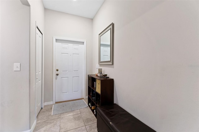 doorway to outside featuring light tile flooring