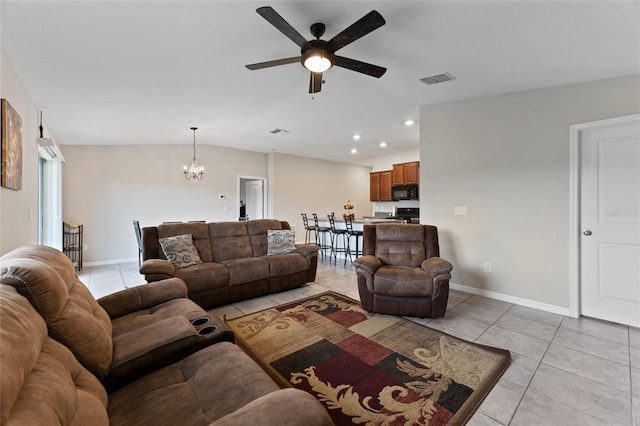 tiled living room featuring ceiling fan with notable chandelier