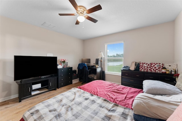 bedroom with light hardwood / wood-style floors and ceiling fan