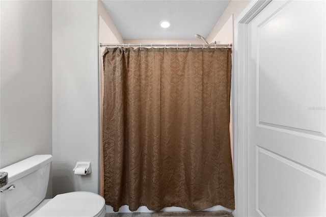 bathroom featuring toilet and a textured ceiling