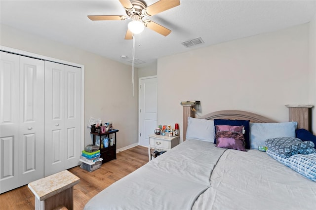 bedroom featuring hardwood / wood-style floors, a closet, and ceiling fan