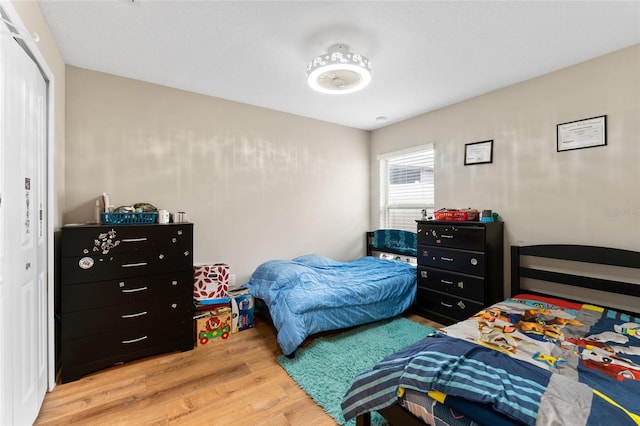 bedroom with a closet and light hardwood / wood-style flooring